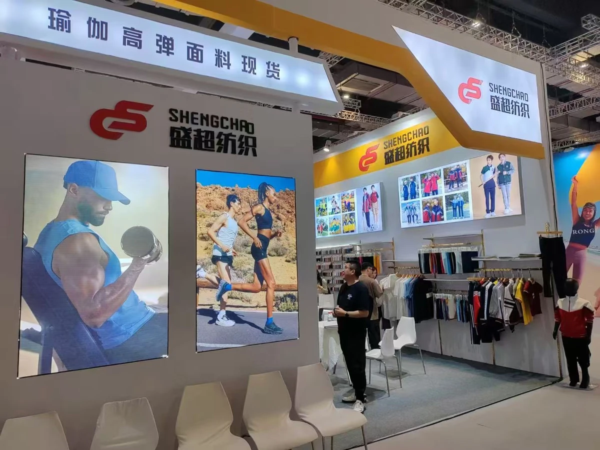 Visitors reviewing Shengchao Textile fabric collections at Ningbo Textile Exhibition